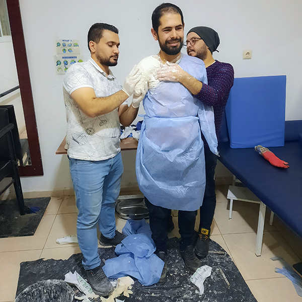 two students casting a model patient for an upper limb prosthesis
